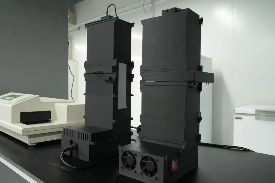 Our plate readers, with the prototype on the left, beside a commercial plate reader